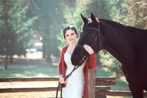 Bride walking with horses — Stock Photo, Image