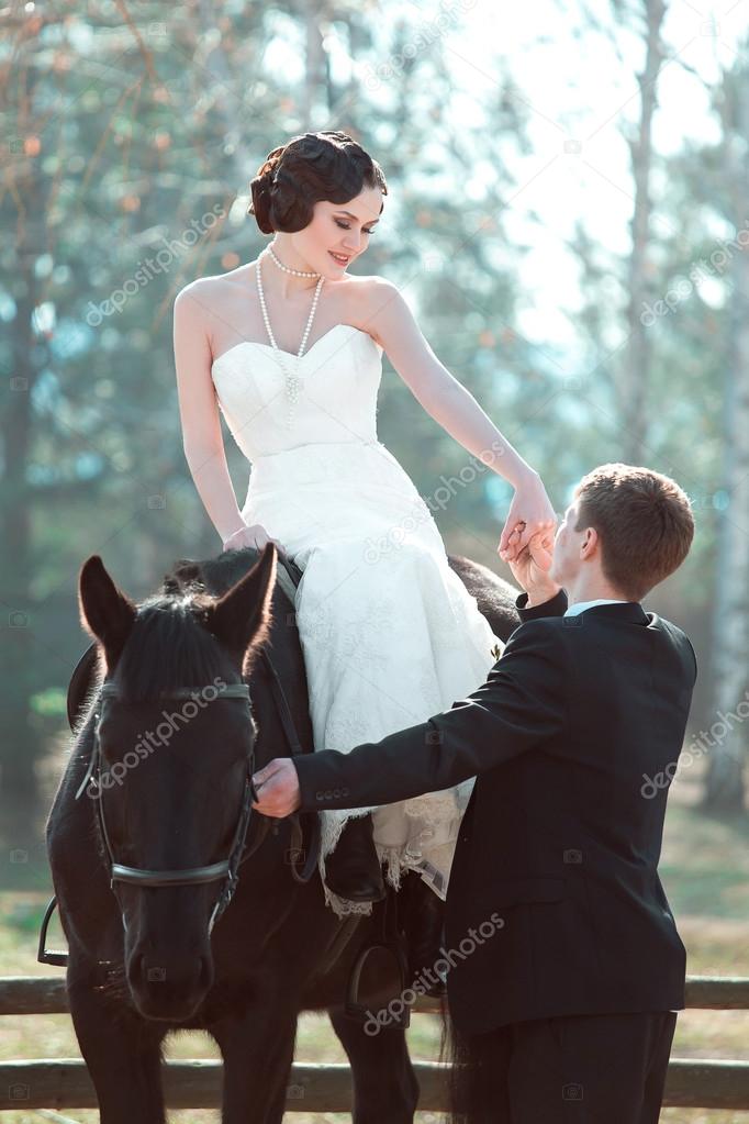 bride and groom walking with horses