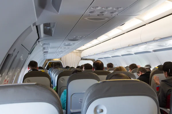 Interior of airplane with passengers — Stock Photo, Image