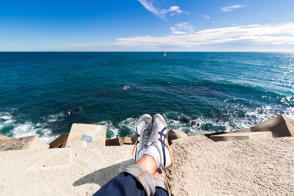 Las piernas de los hombres relajándose en el mar — Foto de Stock
