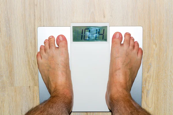 Man standing on weight scales