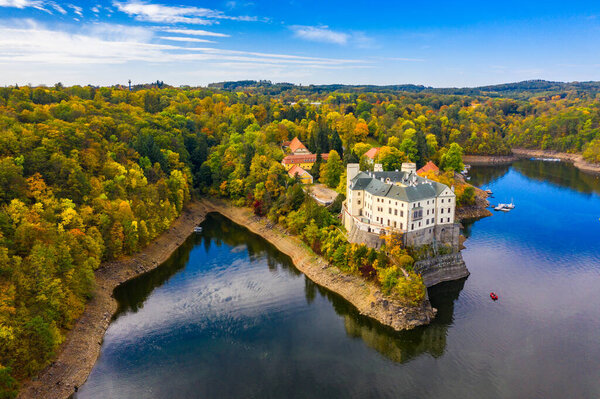 Aerial view chateau Orlik, above Orlik reservoir in beautiful autumn nature. Romantic royal Schwarzenberg castle above water level. Czechia. Orlik castle across the River Vltava, Czech Republic.