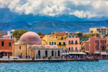 Mosque in the old Venetian harbor of Chania town on Crete island, Greece. Old mosque in Chania. Janissaries or Kioutsouk Hassan Mosque in Chania Crete. Turkish mosque in Chania bay. Crete, Greece. clipart