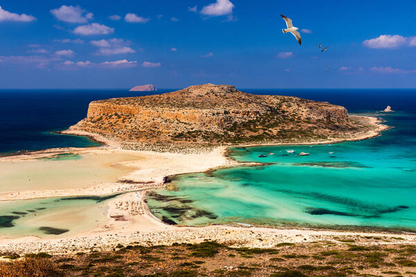 Balos Lagoon and Gramvousa island on Crete with seagulls flying over, Greece. Cap tigani in the center. Balos beach on Crete island, Greece. Crystal clear water of Balos beach.