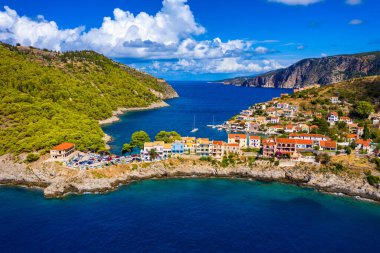 Yunanistan 'ın Kefalonya kentindeki Assos köyünde güzel renkli evleri olan Akdeniz' deki turkuaz renkli körfez. Akdeniz 'de renkli evleri olan Assos kasabası, Yunanistan. 