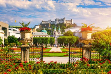 Beautiful view of famous Mirabell Gardens with the old historic Fortress Hohensalzburg in the background in Salzburg, Austria. Famous Mirabell Gardens with historic Fortress in Salzburg, Austria.