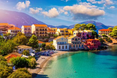 Assos village in Kefalonia, Greece. Turquoise colored bay in Mediterranean sea with beautiful colorful houses in Assos village in Kefalonia, Greece, Ionian island, Cephalonia, Assos village. clipart