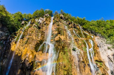 Waterfall with rainbow in national park Plitvice