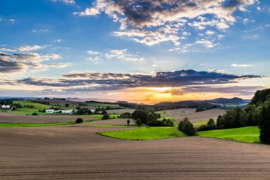 Beautiful sunset over countryside landscape clipart