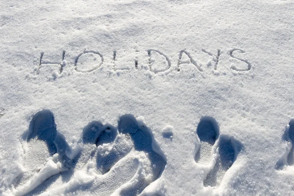 Geschreven woord vakantie op een sneeuwveld — Stockfoto