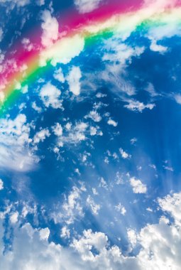 Rainbow in the sky with clouds clipart