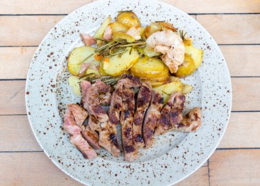 Grilled pork steak and baked potatoes