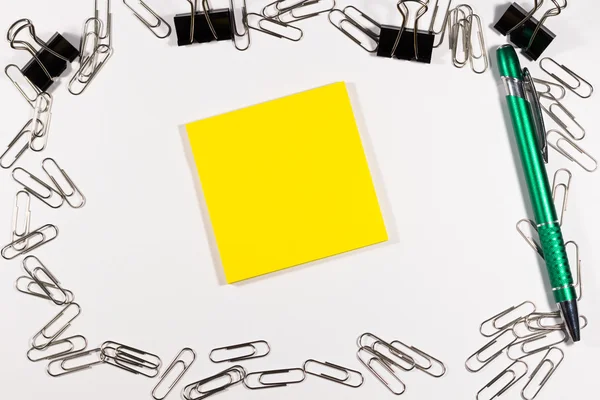 Notebook covered with silver clips and pen — Stock Photo, Image