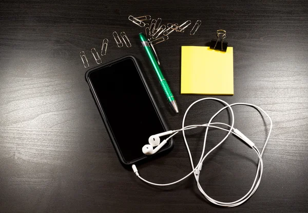 Smartphone on wooden table.