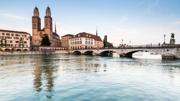 ZURICH, SWITZERLAND - JULY 4: Famous postcard view of various houses and churches in the old town part of Zurich at sunset on July 4, 2015. Zurich is the biggest city in Switzerland.