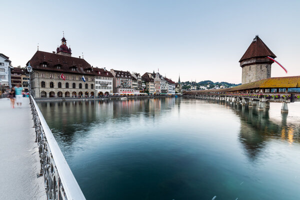 LUCERNE, SWITZERLAND - AUGUST 2: Views of the famous bridge Kapellbruecke at sunset in Lucerne on August 2, 2015. Lucerne is a famous tourist destination in Switzerland.