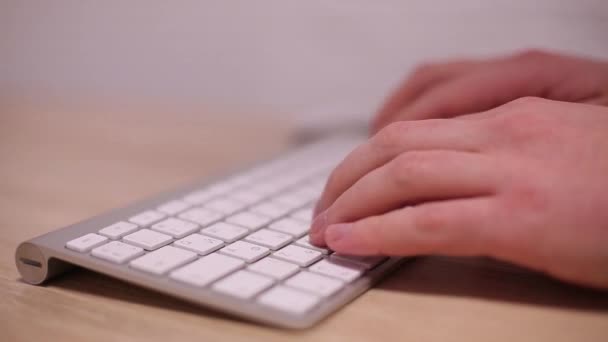 Mann tippt auf weißer Tastatur — Stockvideo