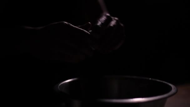 Man breaks an egg in the dark — Stock Video