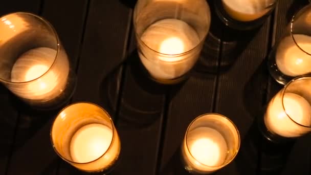 Burning candles on the wooden floor — Stock Video