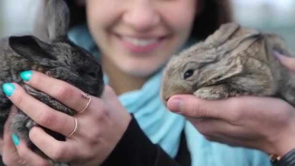 Men and girl holding rabbits in hands — Stock Video