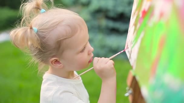 Kislány támaszkodik egy festőállvány — Stock videók