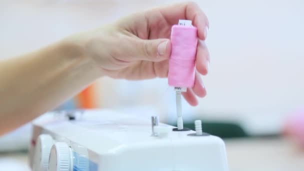 Pink coil on white sewing machine — Stock Video