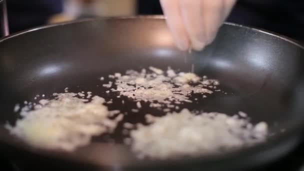 Chef vierte queso rallado en la sartén — Vídeos de Stock