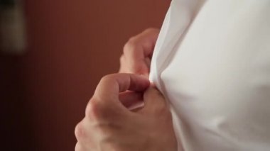 Adam beyaz bir gömlek kadar düğmelerini