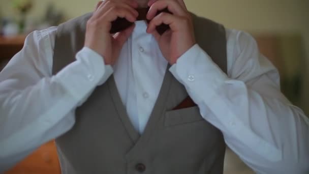 Man in the white shirt correcting bow-tie — Stock Video