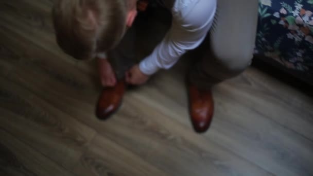 Man tying the laces on the brown shoes, oxfords — Stock Video