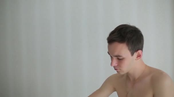 Man brunette wears a t-shirt in the morning — Stock Video