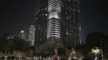 Night View of Modern Skyscraper Architecture and Water Fountain