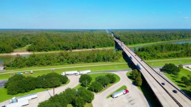 Aerial View of a Highway Bridge Over Swampland with Rest Area