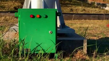 Green Electrical Control Panel with Status Lights on an Industrial Base
