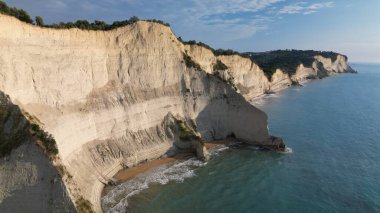 Akdeniz turkuazına bakan dramatik beyaz kireçtaşı kayalıkları.