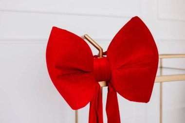 Altın tutacağında asılı büyük kırmızı bir fiyonk