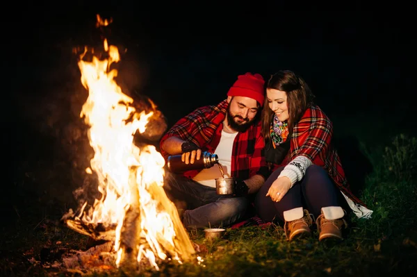 lovers around the campfire at night
