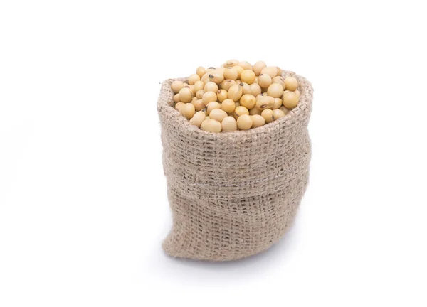 Soy beans in gunny bag isolated on white background — Stock Photo, Image