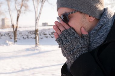 Man sneezing in winter