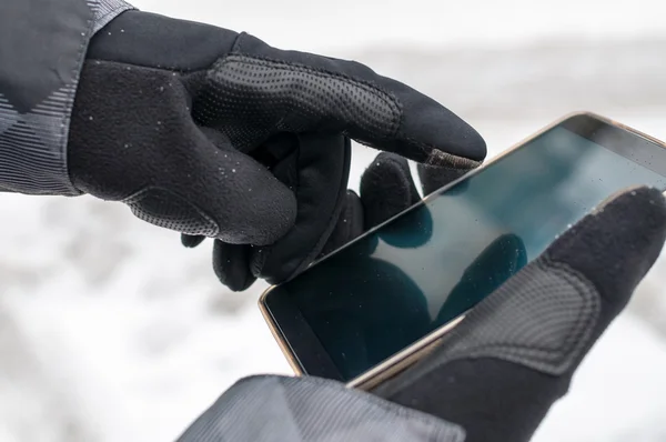 Man uses smartphone in winter Stok Resim