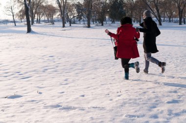 Couple running in winter forest