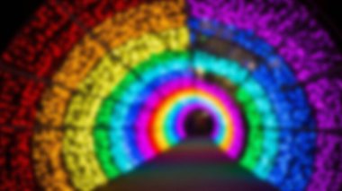 Abstract blurred image of a rainbow-colored light tunnel.