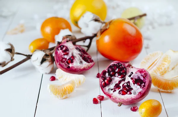 Winter fruits - pomegranates, tangerines, oranges, persimmons, kumquats — Stock Photo, Image