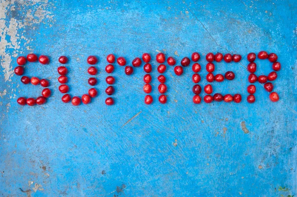 Word Summer made of cherries on textured blue background — Stock Photo, Image