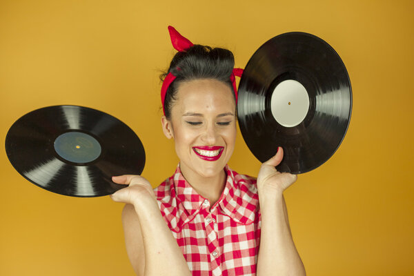 Close up portrait beautiful pin up girl with old vinil records