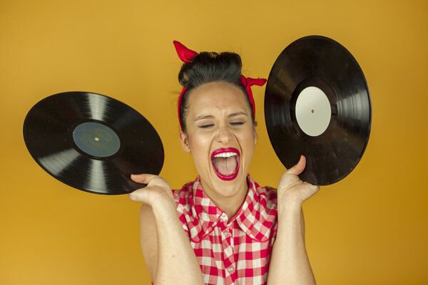 Close up portrait beautiful pin up girl with old vinil records