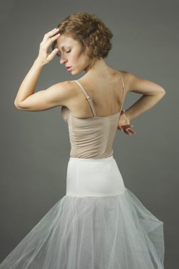 Young expressive ballerina with practicing ballet by herself