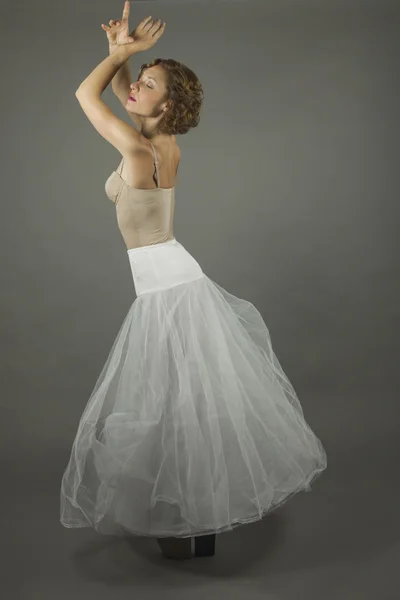Young expressive ballerina with a white long tutu practicing bal Stock Photo