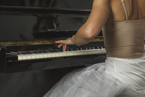 Stäng upp ballerina hand spela piano — Stockfoto