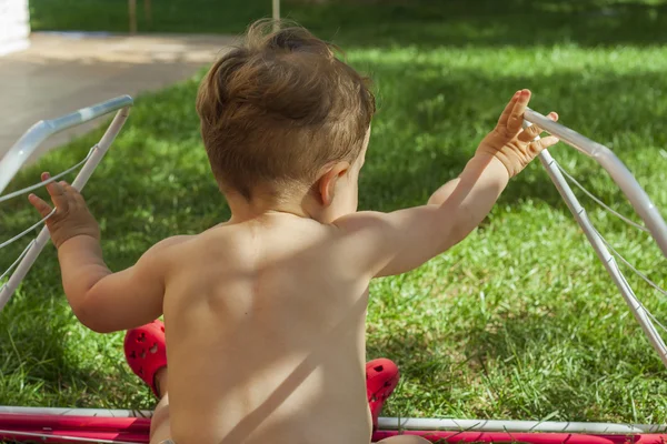 Bakre Visa porträtt söt baby pojke leker med en tvättlina. — Stockfoto